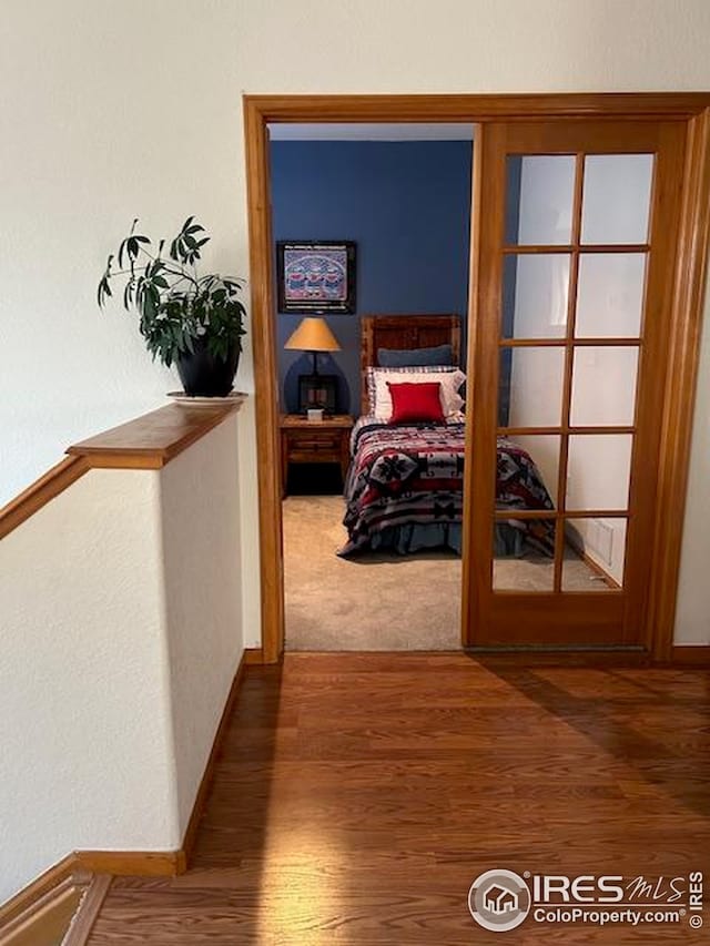 hall featuring wood finished floors and baseboards