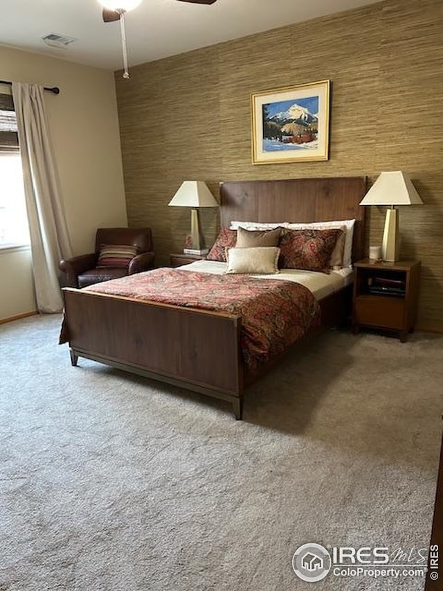 bedroom featuring a ceiling fan, carpet flooring, baseboards, and visible vents
