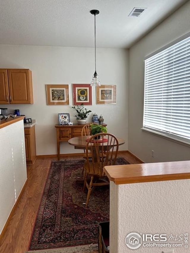 dining room with visible vents and light wood finished floors