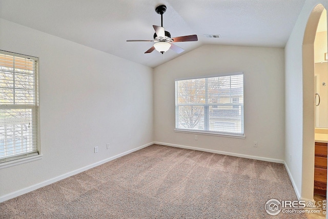 3740 Ponderosa Ct Unit 2, Evans, CO 80620 - spare room with lofted ceiling, carpet flooring, visible vents, ceiling fan, and baseboards