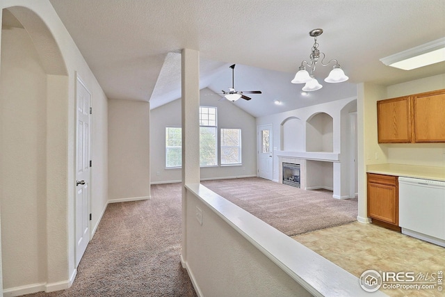 3740 Ponderosa Ct Unit 2, Evans, CO 80620 - kitchen featuring a fireplace, decorative light fixtures, light carpet, dishwasher, and ceiling fan with notable chandelier