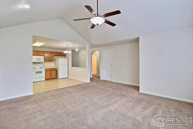 3740 Ponderosa Ct Unit 2, Evans, CO 80620 - unfurnished living room with arched walkways, light carpet, baseboards, high vaulted ceiling, and a ceiling fan