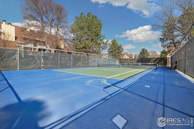 view of tennis court with fence