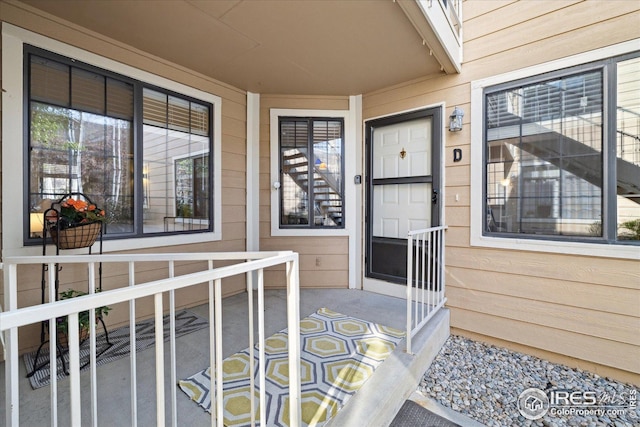 view of exterior entry with a porch