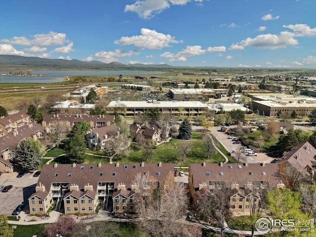 drone / aerial view with a water and mountain view