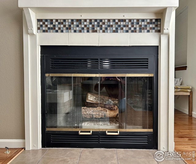 interior details featuring baseboards and a fireplace