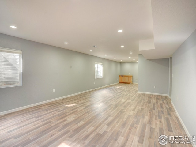 below grade area featuring recessed lighting, light wood finished floors, and baseboards