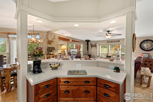 kitchen featuring brown cabinets, light countertops, recessed lighting, light wood finished floors, and a ceiling fan