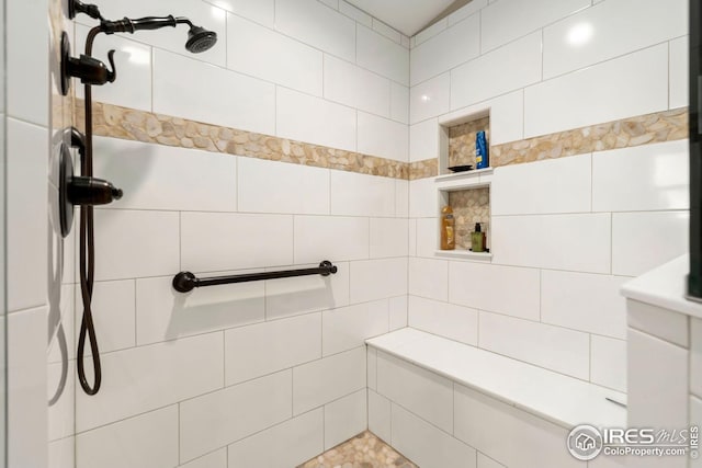 bathroom with tiled shower