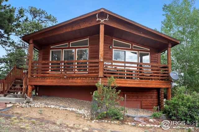 back of property with a wooden deck