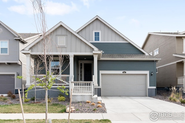 craftsman-style house featuring driveway, board and batten siding, a porch, and an attached garage