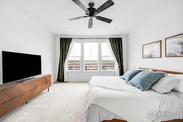 bedroom with light carpet and ceiling fan