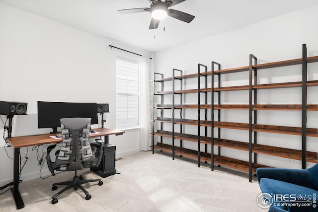 office area with light colored carpet, ceiling fan, and baseboards