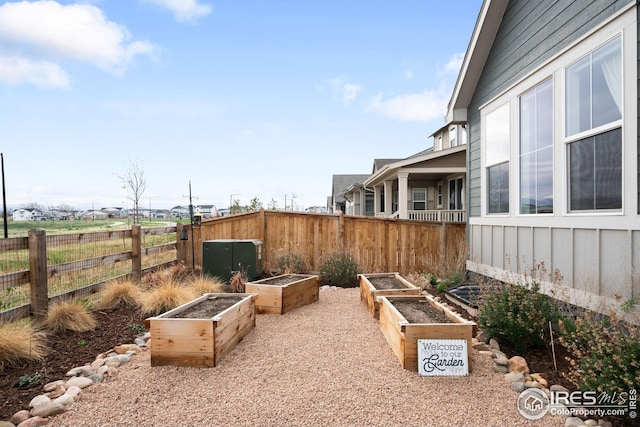 view of yard with fence and a garden