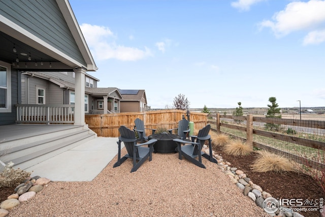view of yard with fence, a patio area, and an outdoor fire pit