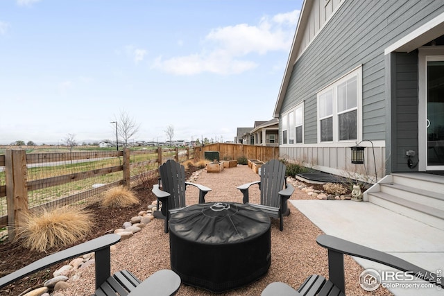 view of patio / terrace with fence and an outdoor fire pit