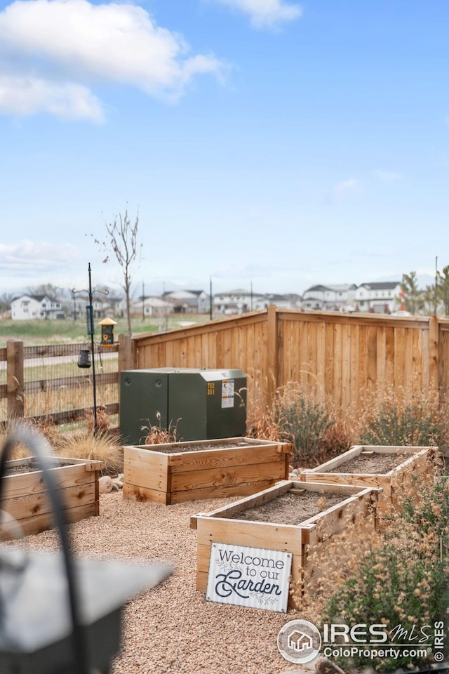 view of yard with fence and a vegetable garden