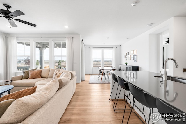 living area featuring recessed lighting, a ceiling fan, and light wood-type flooring
