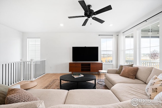 living room with wood finished floors, a ceiling fan, recessed lighting, and baseboards