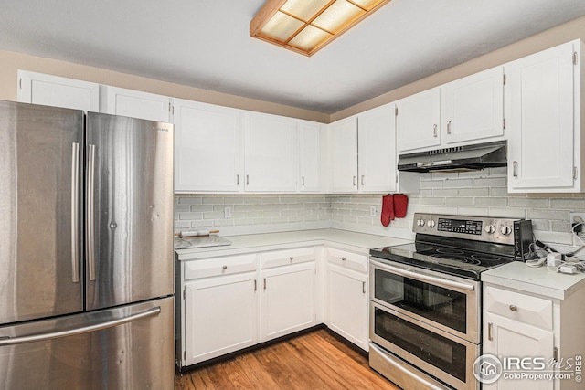 kitchen with stainless steel appliances, under cabinet range hood, and light countertops