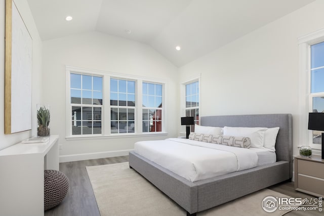 bedroom with recessed lighting, wood finished floors, and lofted ceiling