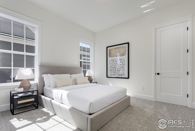 bedroom featuring carpet and baseboards