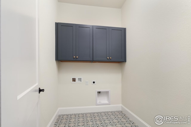 washroom featuring hookup for an electric dryer, hookup for a washing machine, cabinet space, and baseboards