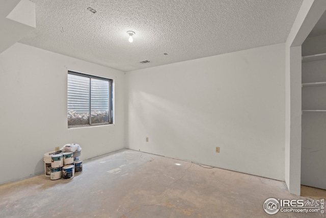 interior space featuring a textured ceiling and visible vents