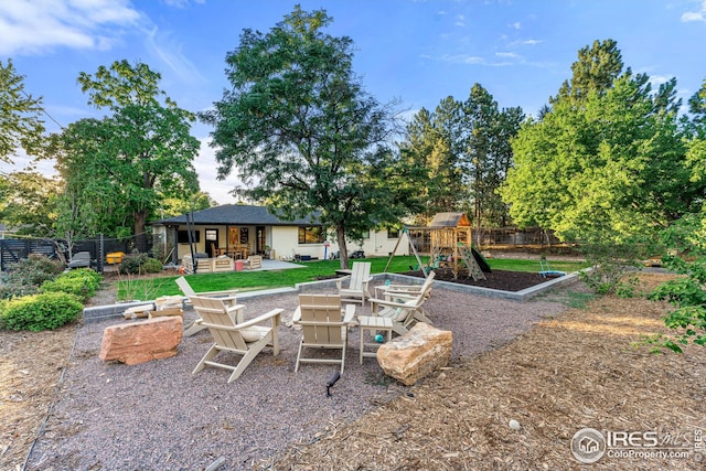 exterior space featuring fence, a fire pit, and a patio area