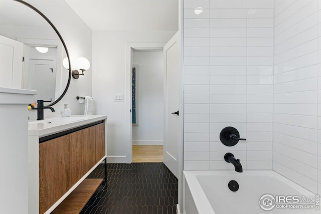 bathroom with baseboards, tile patterned flooring, tub / shower combination, and vanity