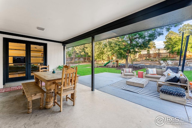 view of patio / terrace featuring fence, an outdoor hangout area, outdoor dining area, french doors, and a playground