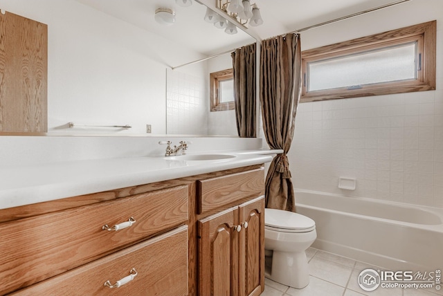 bathroom featuring toilet, vanity, shower / bath combo with shower curtain, and tile patterned floors