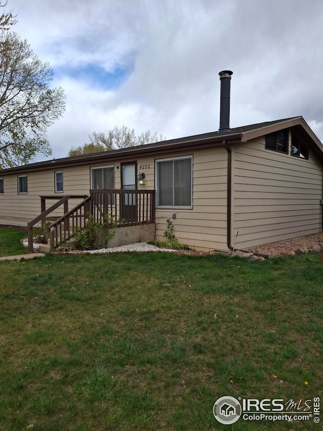 rear view of house with a yard