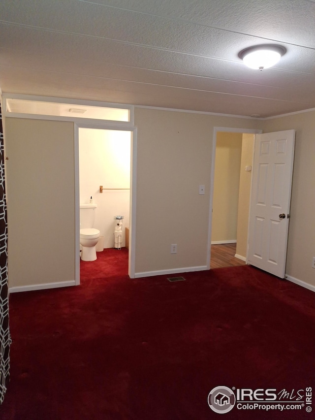 unfurnished room featuring visible vents, carpet, and baseboards