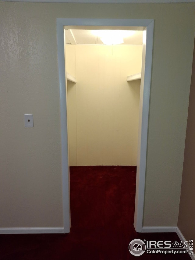 hall featuring baseboards