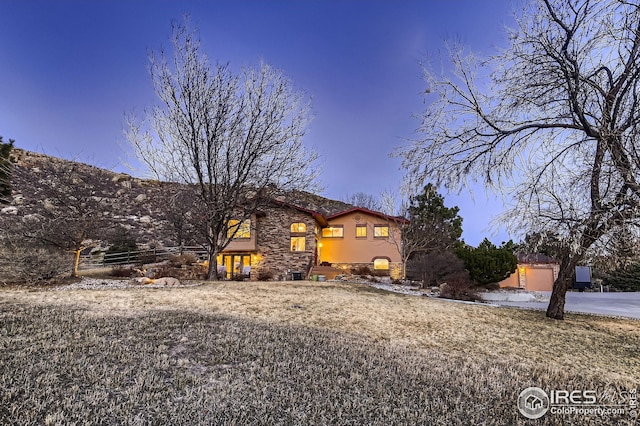 view of front of home with stucco siding and stone siding