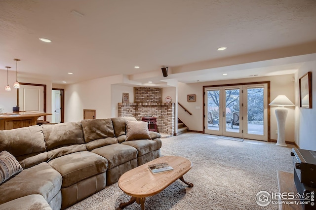 carpeted living area featuring recessed lighting, stairs, and baseboards