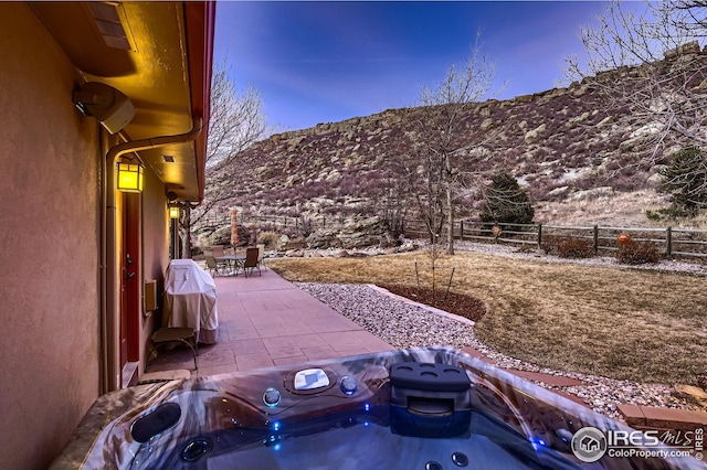 view of patio featuring outdoor dining space, a mountain view, area for grilling, and fence