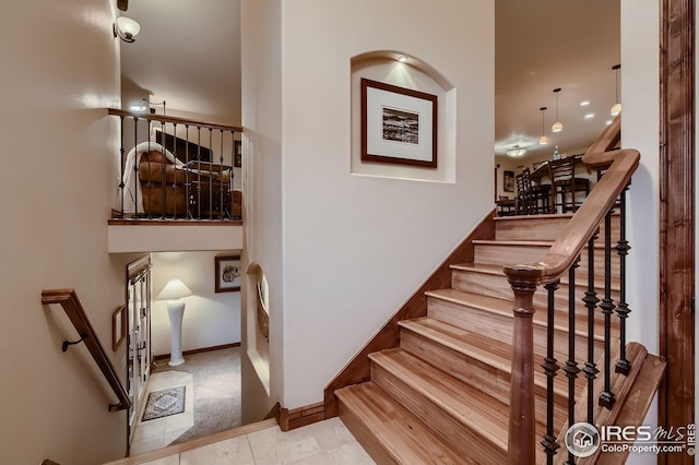 stairs with carpet floors and baseboards