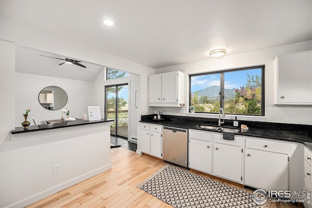 kitchen featuring a sink, light wood-style flooring, white cabinetry, and dishwasher