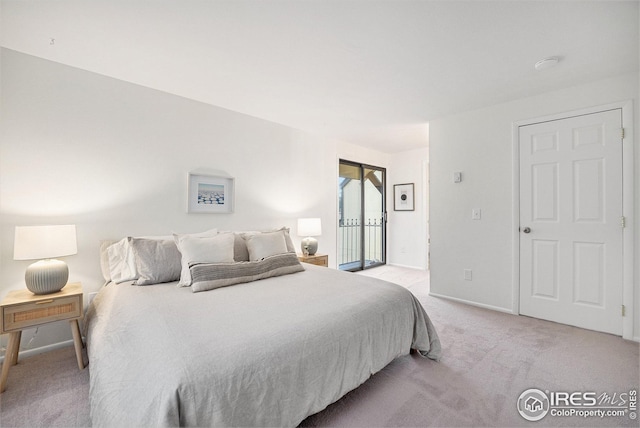 bedroom featuring access to outside, baseboards, and light colored carpet