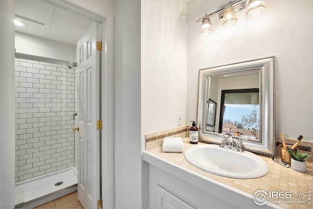 bathroom featuring a shower stall and vanity