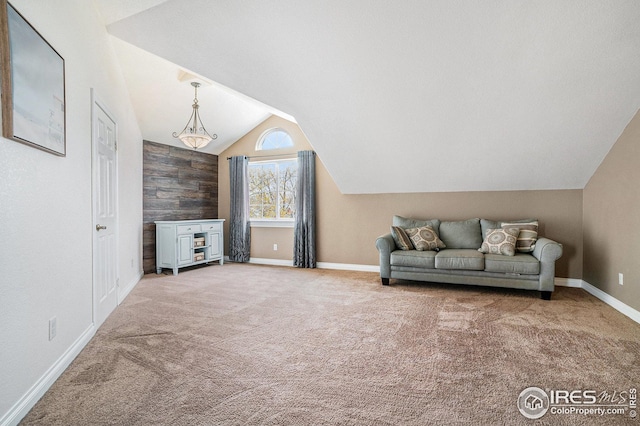 carpeted living area featuring baseboards and lofted ceiling