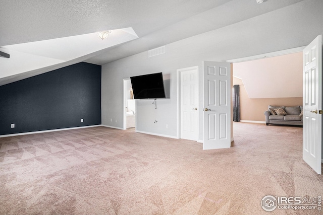 additional living space with baseboards, carpet flooring, and vaulted ceiling