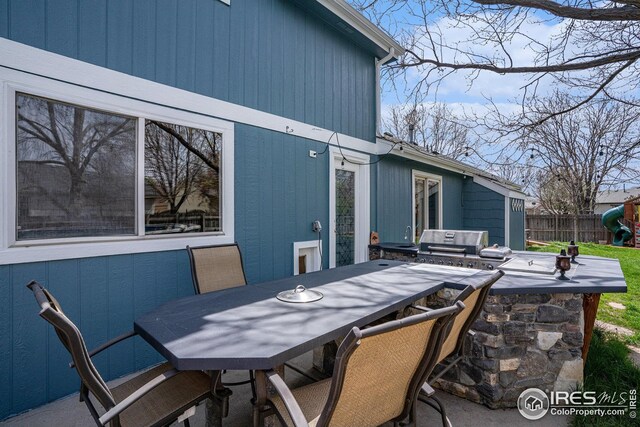 view of patio featuring fence and area for grilling