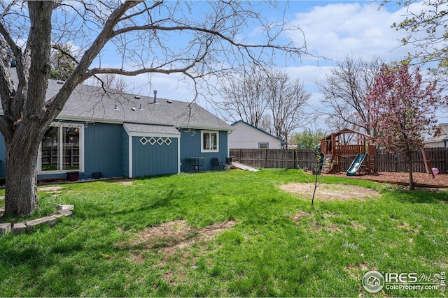 view of yard featuring a playground and a fenced backyard