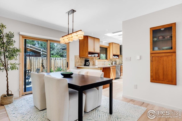 dining room featuring baseboards and light wood-style flooring