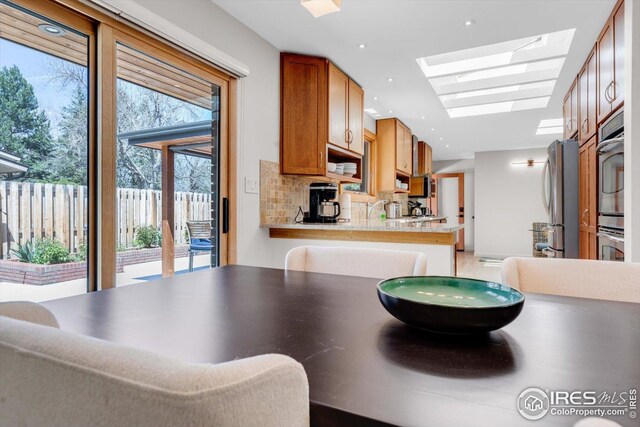 dining room with recessed lighting and a skylight