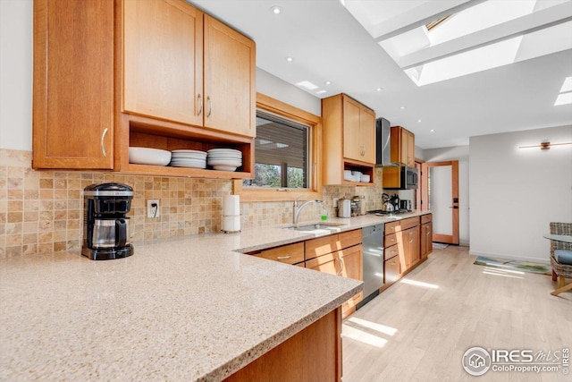 kitchen featuring stainless steel appliances, open shelves, a skylight, and a sink