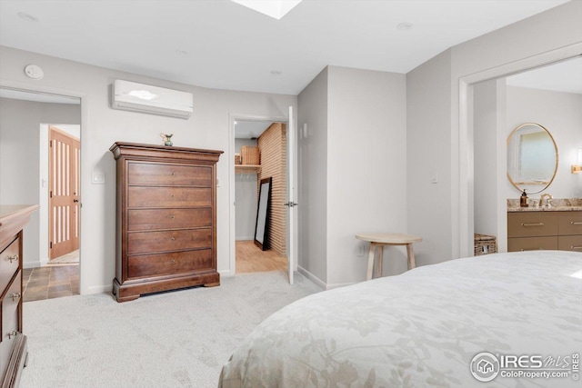 carpeted bedroom with baseboards, a sink, and a wall mounted AC